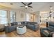 Comfortable living room with a large gray sectional, ceiling fan, and adjacent access to the kitchen at 13432 N 154Th Ln, Surprise, AZ 85379