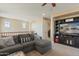 Spacious living room featuring a large entertainment center and comfortable gray sectional couch at 13432 N 154Th Ln, Surprise, AZ 85379