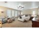 Inviting main bedroom with sitting area, ceiling fan, and plenty of natural light from large windows at 13432 N 154Th Ln, Surprise, AZ 85379