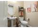 Charming powder room with pedestal sink, decorative mirror, and stylish wall accents at 13432 N 154Th Ln, Surprise, AZ 85379