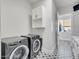 Clean and organized laundry room with modern appliances and stylish tile flooring at 13613 N 76Th St, Scottsdale, AZ 85260