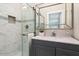 Modern bathroom with a sleek vanity, decorative mirror, and a glass shower at 13613 N 76Th St, Scottsdale, AZ 85260