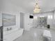 Bright bathroom features a chandelier, free standing tub, glass enclosed shower, and stylish gray tile flooring at 13613 N 76Th St, Scottsdale, AZ 85260