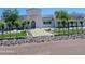 Elegant home featuring sleek, light architecture, manicured greenery, and stylish rock landscaping at 13613 N 76Th St, Scottsdale, AZ 85260