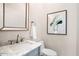 Stylish powder room features a marble countertop, elegant fixtures, and decorative wall art at 13613 N 76Th St, Scottsdale, AZ 85260