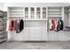 Well-organized walk-in closet featuring custom shelving, drawers, and hanging space for clothes at 13613 N 76Th St, Scottsdale, AZ 85260