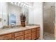 Bathroom vanity with dual sinks, granite countertops, and a glass-enclosed shower at 15241 E Pageland Cir, Fountain Hills, AZ 85268