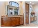 Bathroom features wooden cabinetry, granite counters, and a beautiful arched window at 15241 E Pageland Cir, Fountain Hills, AZ 85268