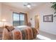 Bedroom features a sliding glass door to balcony and southwestern style decor at 15241 E Pageland Cir, Fountain Hills, AZ 85268