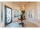 Bright foyer with unique front door, plantation shutters, and tiled flooring at 15241 E Pageland Cir, Fountain Hills, AZ 85268