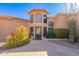 Stunning home entrance with a unique glass door, desert landscaping, and a welcoming walkway at 15241 E Pageland Cir, Fountain Hills, AZ 85268