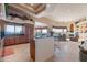 Open concept kitchen featuring granite countertops, wooden cabinets, and views of the living room at 15241 E Pageland Cir, Fountain Hills, AZ 85268