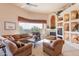 Cozy living room with fireplace, built-in shelving, comfortable seating, and scenic views at 15241 E Pageland Cir, Fountain Hills, AZ 85268