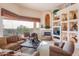 Cozy living room with fireplace, built-in shelving, comfortable seating, and scenic views at 15241 E Pageland Cir, Fountain Hills, AZ 85268