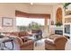 Bright and airy living room featuring fireplace, built-in shelving, and comfortable furnishings at 15241 E Pageland Cir, Fountain Hills, AZ 85268