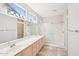 Bathroom featuring dual sinks, a large mirror, and glass-enclosed walk-in shower at 15525 W Clear Canyon Dr, Surprise, AZ 85374