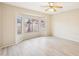 Large bay windows flood this bedroom with natural light and views of the lush landscaping at 15525 W Clear Canyon Dr, Surprise, AZ 85374