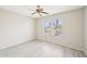 Bright bedroom with gray wood laminate flooring and natural light with the view of desert trees at 15525 W Clear Canyon Dr, Surprise, AZ 85374