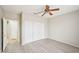 Bright bedroom with light gray walls, modern fan, and double door closet is ready for new residents at 15525 W Clear Canyon Dr, Surprise, AZ 85374