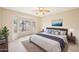 Spacious main bedroom featuring a large window, king bed, wood floors, and calming neutral color palette at 15525 W Clear Canyon Dr, Surprise, AZ 85374