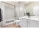 Bright bathroom featuring a shower-over-tub, tiled surround, and white vanity at 16013 S Desert Foothills Pkwy # 2082, Phoenix, AZ 85048