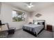 Inviting bedroom with a ceiling fan, a view-enhancing window, and comfortable carpeting, creating a cozy ambiance at 16013 S Desert Foothills Pkwy # 2082, Phoenix, AZ 85048