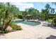 Resort-style community pool with seating, lush landscaping, and shade structures at 16013 S Desert Foothills Pkwy # 2082, Phoenix, AZ 85048