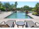 Inviting community pool featuring a water feature, lounge chairs and landscaped surroundings at 16013 S Desert Foothills Pkwy # 2082, Phoenix, AZ 85048