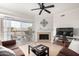 Living room with fireplace, ceiling fan and sliding glass doors at 16013 S Desert Foothills Pkwy # 2082, Phoenix, AZ 85048