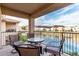 Beautiful patio with seating overlooking a serene lake and lush landscaping at 16013 S Desert Foothills Pkwy # 2082, Phoenix, AZ 85048