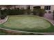 Community putting green surrounded by lush green grass and beautiful landscaping at 16013 S Desert Foothills Pkwy # 2082, Phoenix, AZ 85048