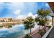 Scenic lake view from a private balcony, framed by mature trees and plants at 16013 S Desert Foothills Pkwy # 2082, Phoenix, AZ 85048