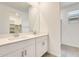 Bathroom with double sink vanity, framed mirror and access to the shower at 16036 W Desert Hollow Dr, Surprise, AZ 85387