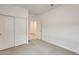 This bedroom features neutral carpet, white walls, a closet and access to other rooms at 16036 W Desert Hollow Dr, Surprise, AZ 85387