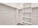 Walk-in closet is designed with rods for hanging and shelves for folded clothing at 16036 W Desert Hollow Dr, Surprise, AZ 85387