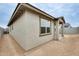 View of the exterior wall and covered patio of this single-story home at 16036 W Desert Hollow Dr, Surprise, AZ 85387