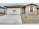 Charming single-Gathering home featuring a two-car garage and neutral stucco exterior with stone accents at 16036 W Desert Hollow Dr, Surprise, AZ 85387