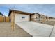 Charming single-Gathering home featuring a two-car garage and neutral stucco exterior with stone accents at 16036 W Desert Hollow Dr, Surprise, AZ 85387