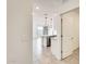 Hallway with tile floors leading into the open kitchen/living space, showcasing the home's layout at 16036 W Desert Hollow Dr, Surprise, AZ 85387