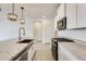 Modern kitchen features a center island with a sink and stainless steel appliances at 16036 W Desert Hollow Dr, Surprise, AZ 85387