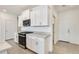 Modern kitchen with stainless appliances, granite countertops, and white cabinets at 16036 W Desert Hollow Dr, Surprise, AZ 85387