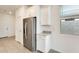 Bright kitchen featuring stainless steel appliances, white cabinetry, and neutral tiling at 16036 W Desert Hollow Dr, Surprise, AZ 85387