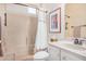 Cozy bathroom featuring shower-over-tub and single sink vanity with tiled countertop at 16172 W Starlight Dr, Surprise, AZ 85374