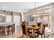 Cozy dining area with wood table and chairs adjacent to bright outdoor patio through sliding glass doors at 16172 W Starlight Dr, Surprise, AZ 85374