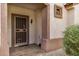 Charming home entrance features a secure screen door and well-maintained landscaping at 16172 W Starlight Dr, Surprise, AZ 85374