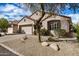 Attractive single-story home with desert landscaping, and an attached two-car garage at 16172 W Starlight Dr, Surprise, AZ 85374