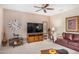 Inviting living room with plush seating, a ceiling fan, and natural light at 16172 W Starlight Dr, Surprise, AZ 85374