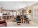 Bright and airy living room features tile floors and seamless transition to the dining area at 16172 W Starlight Dr, Surprise, AZ 85374