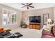 Cozy living room features plantation shutters, ceiling fan, and comfortable furnishings at 16172 W Starlight Dr, Surprise, AZ 85374