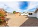 Wide shot of desert landscaped backyard with covered patio and lush bougainvillea at 1640 W Charleston Ave, Phoenix, AZ 85023